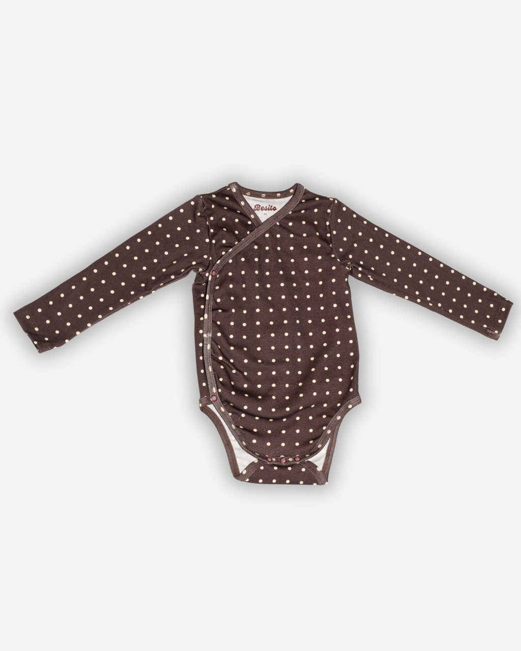 de voorkant van de overslag romper van besito baby in de kleur polka dot