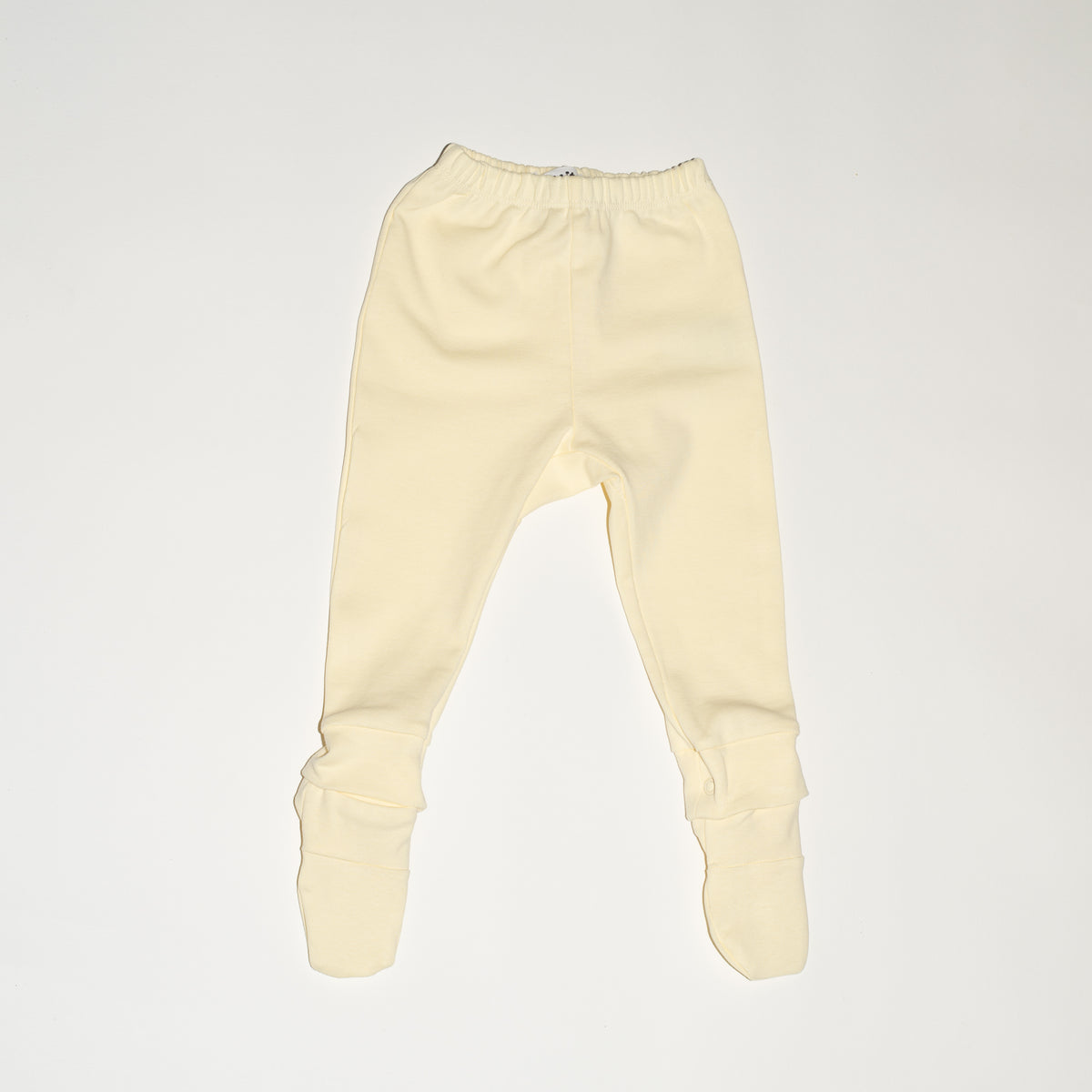 de voorkant van de modular legging van besito baby in butter yellow